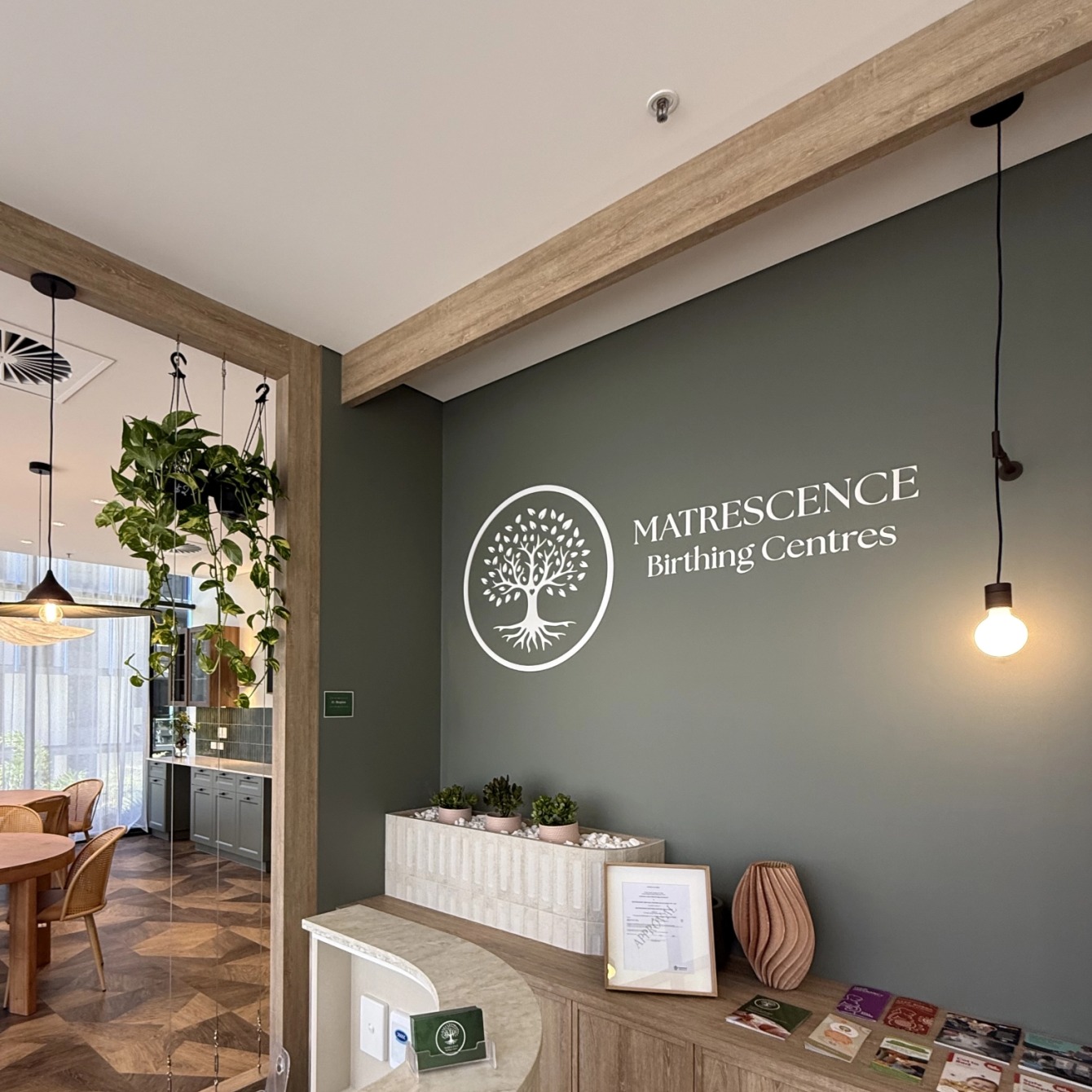The reception area at Matrescence Birthing Centre, with the tree logo on the wall