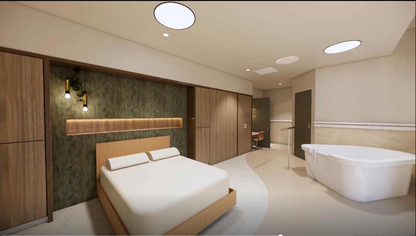 A private birth suite at Matrescence Birthing Centre, with a large bed and birth pool